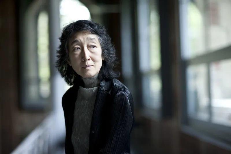 Mitsuko Uchida photographed in a sunlit corridor